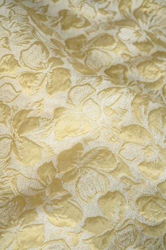 Gold floral printed silk jacquard fabric showing a luminous woven botanical texture