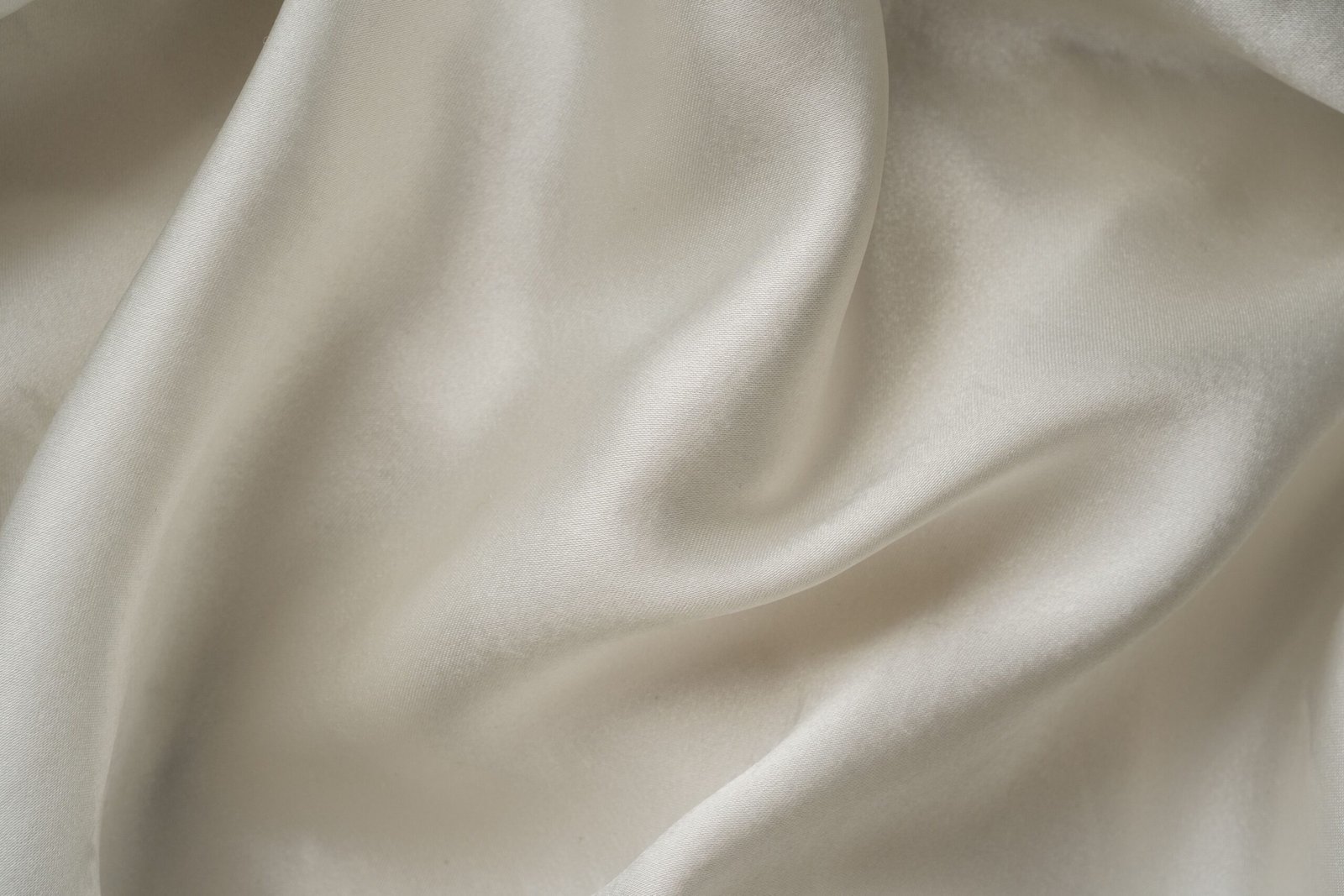 Unprinted ivory silk satin fabric with a natural glossy drape
